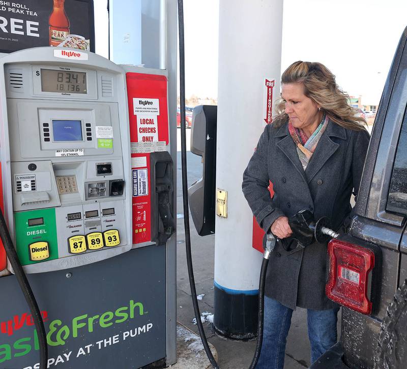 Paula Pinne, from Sycamore, finishes filling up her vehicle at a cost of over $80 Tuesday, March 8, 2022, at the Hy-Vee in Sycamore. US gas prices hit an all time high this week with local stations charging between $4.50 and $5.00 for a gallon of regular unleaded gasoline.