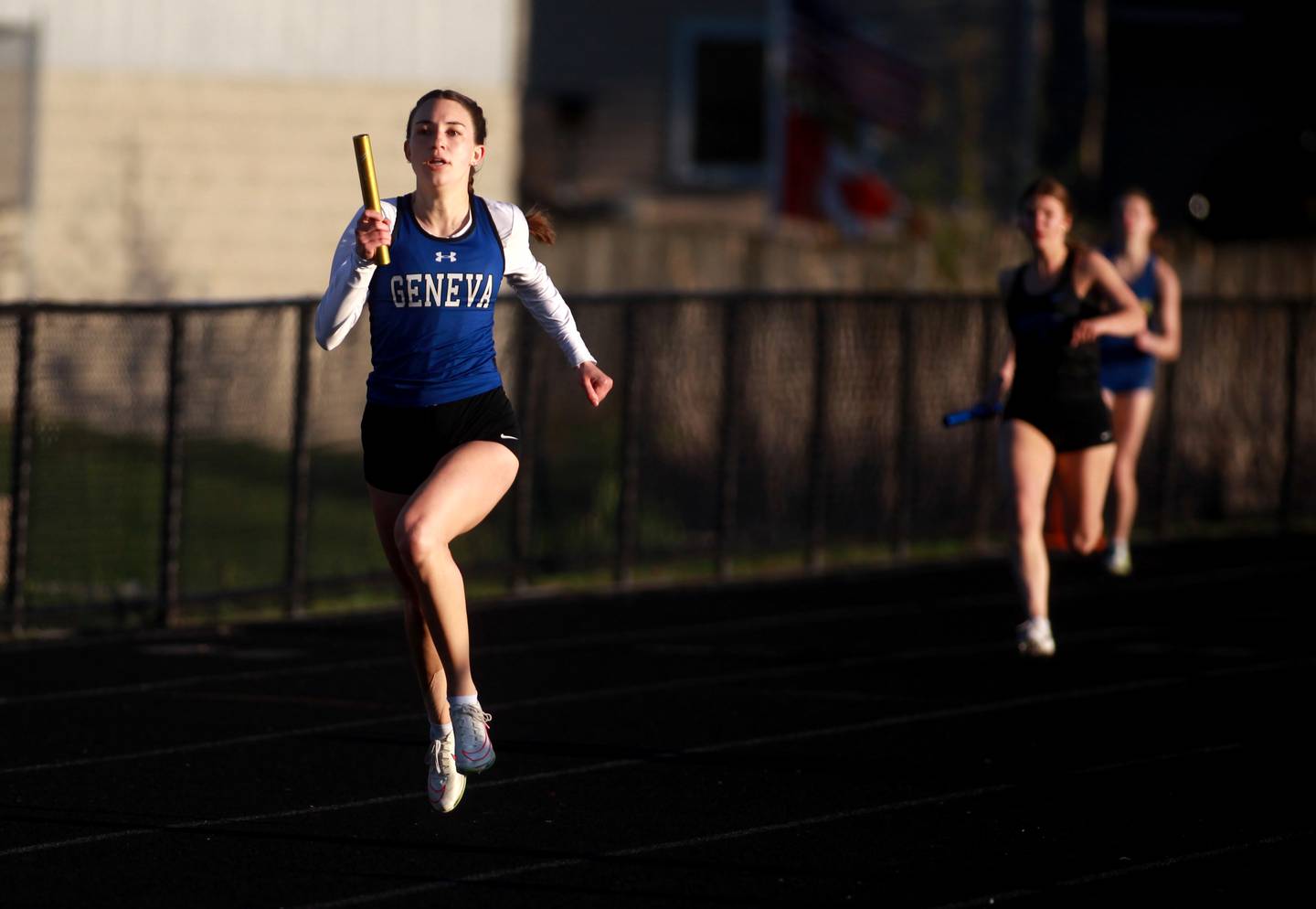 Geneva’s Alyssa Golden runs the third leg of the 4x200-meter relay during the DuKane Conference Girls Outdoor Championship on Thursday, May 8, 2025 at Glenbard North in Carol Stream.