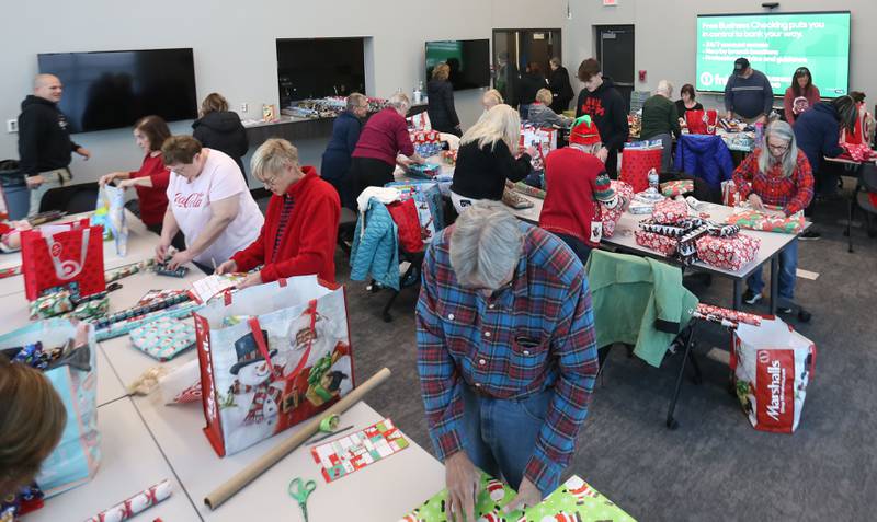 Over 50 volunteers wrapped presents for the Blue and Red Christmas for Kids on Tuesday, Dec. 16, 2025 at the City of Peru Public Safety Complex. Blue and Red will be delivering gifts to 85 children on Friday, Dec. 19. Area schools provided toys to fire and police depratments with childrens names and their Christmas lists. The program relays on donations including a $2,000 donation from the City of Peru in November. The Christmas program was established in 2013 by the Peru police and fire departments. It donates more than gifts to children in need; it provides personalized gifts for each child and family, including clothing and toys.