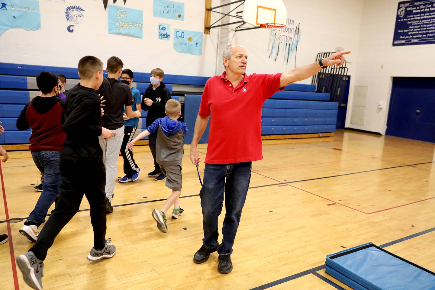 Physical education teacher Corey Toppel teaches a lesson on the shot put to sixth graders at Glen Crest MIddle School in Glen Ellyn. Toppel has been a teacher at the school for 32 years.