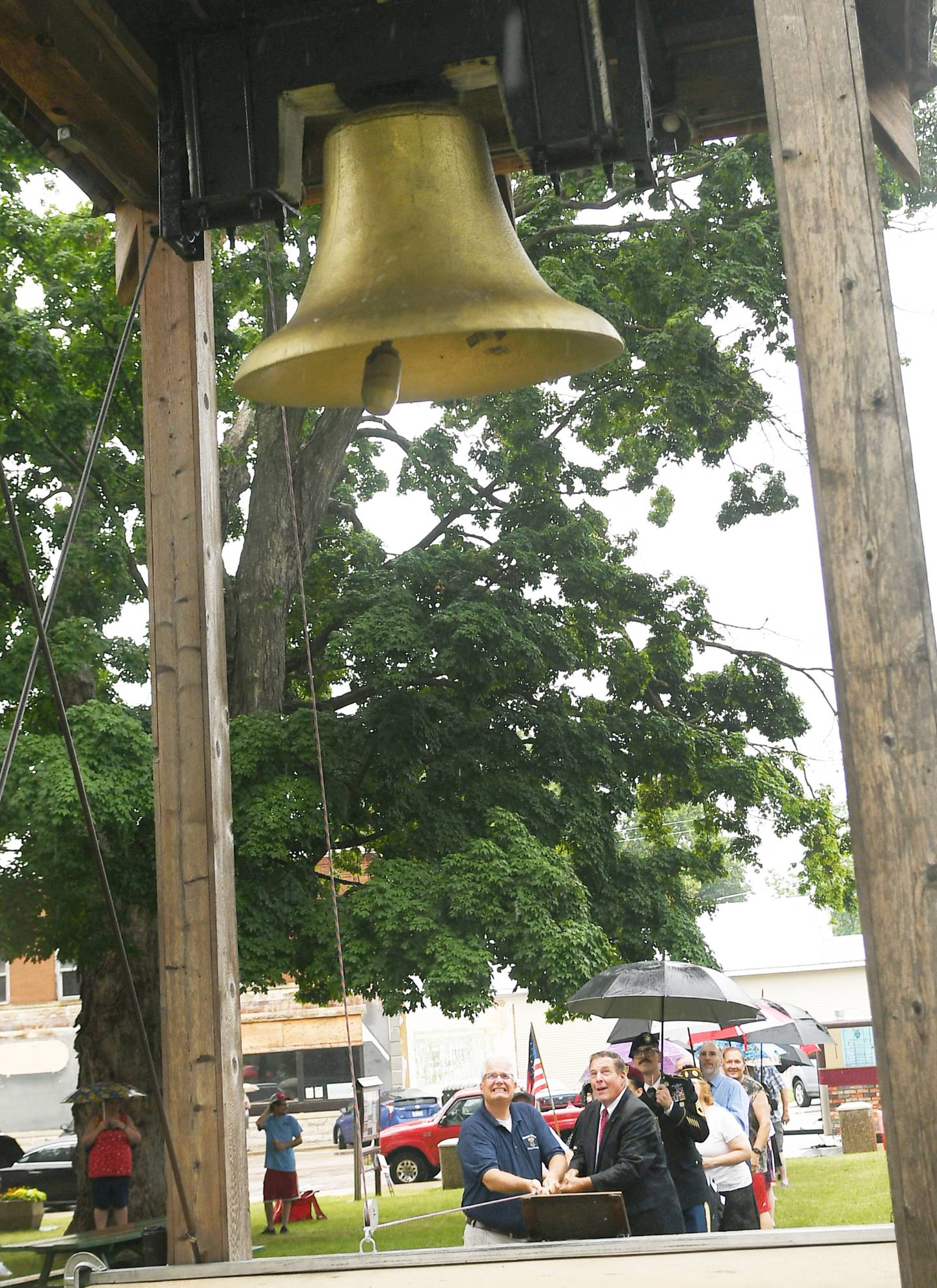 Mt. Morris Village President Phil Labash and Mark Tremble, posing as Ronald Reagan, and a host of others ring the Illinois Freedom Bell 13 times in unison with the Liberty Bell in Philadelphia, Pennsylvania, during the Let Freedom Ring Patriotic Program on July 4.