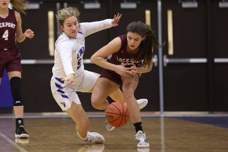 Lincoln-Way East’s Maggie Grady fouls Charlotte Fahrner of Lockport going for the ball in the Class 4A Lincoln-Way East Regional semifinal. Monday, Feb. 14, 2022, in Frankfort.