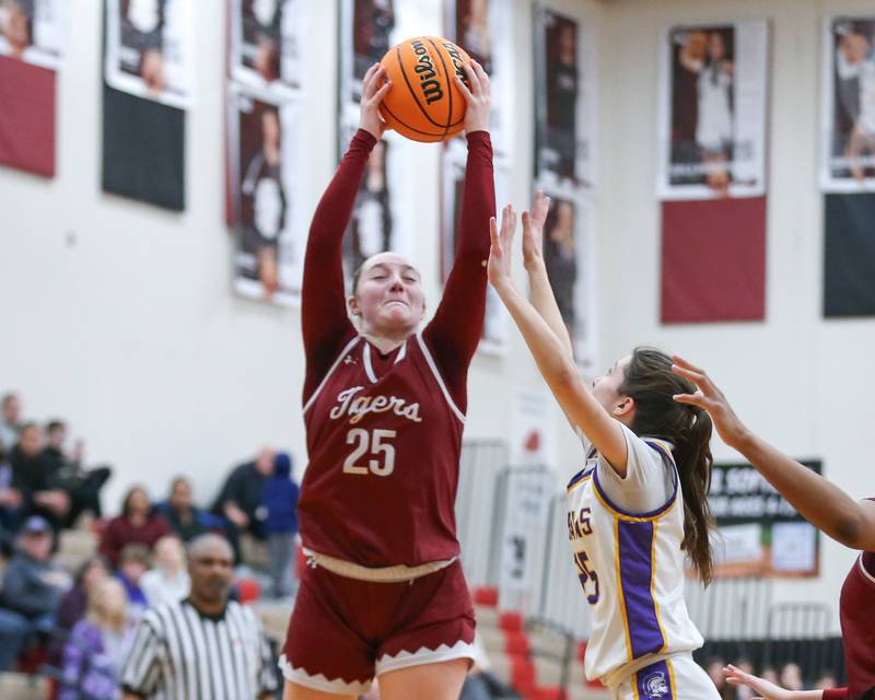 Plainfield North's Sydney Scott (25) leaps high for a rebound during their Regional Final basketball game between Downers Grove North at Plainfield North. Feb 20, 2025 in Plainfield.