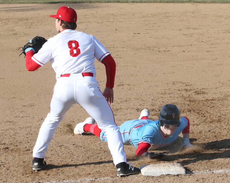 Hall's Ashton Pecher dives back into first base as Ottawa's Rylan Dorsey waits for the late throw on Tuesday, March 28, 2023 at Ottawa High School.