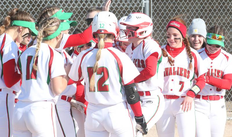 L-P's Addie Duttlinger (center) celebrates with her teammates after hitting a home run against Streator on Wednesday, March 29, 2023 at Veteran's Park in Peru.