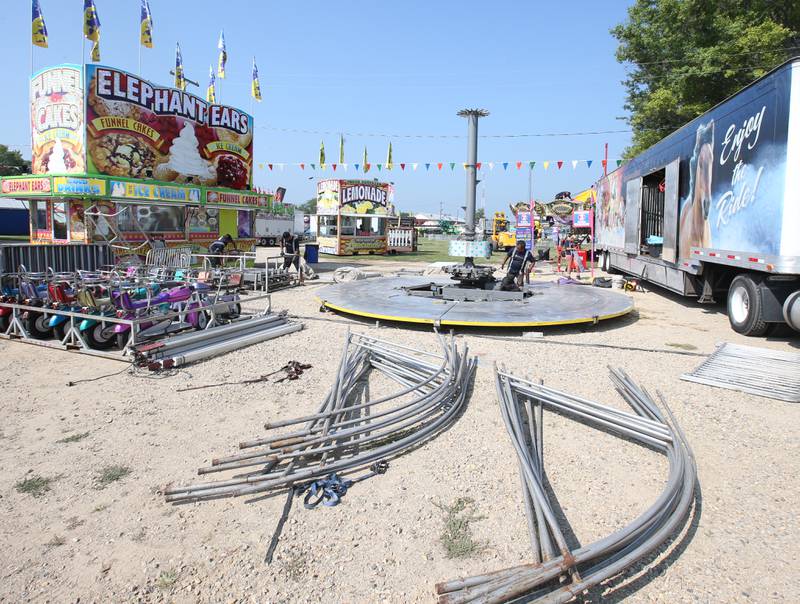 Pieces of equipment are laid out as North American Midway Entertainment carnival workers set up for the 168th annual Bureau County Fair on Tuesday, Aug. 22, 2023 in Princeton.