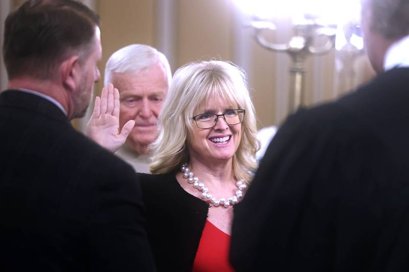 Circuit Clerk Lori Grubbs, accompanied by her family, is sworn in by Chief Judge Bradley Waller Monday, Dec. 2, 2024, during a ceremony at the DeKalb County Courthouse in Sycamore.