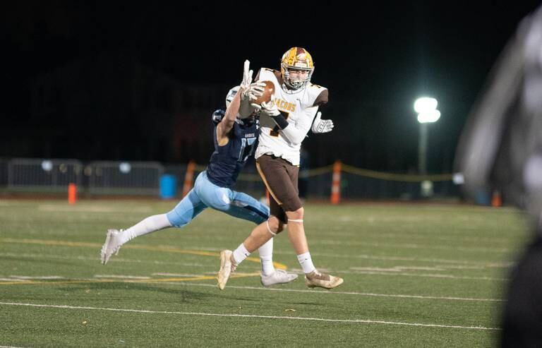 Jacobs’ Grant Stec (7) catches a pass against Prospect's Giovani Paredes (17) during a 7A quarterfinal playoff game at Prospect High School on Saturday, Nov 13, 2021.