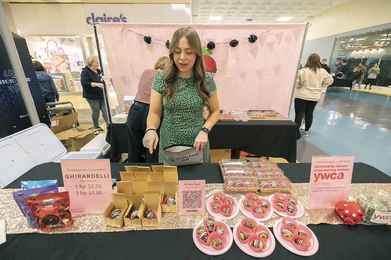 Newman student Ainsley Reed talks about her chocolate dipped strawberries Wednesday, April 26, 2023. Her business name is Indulgence with all her profits going to the YWCA.