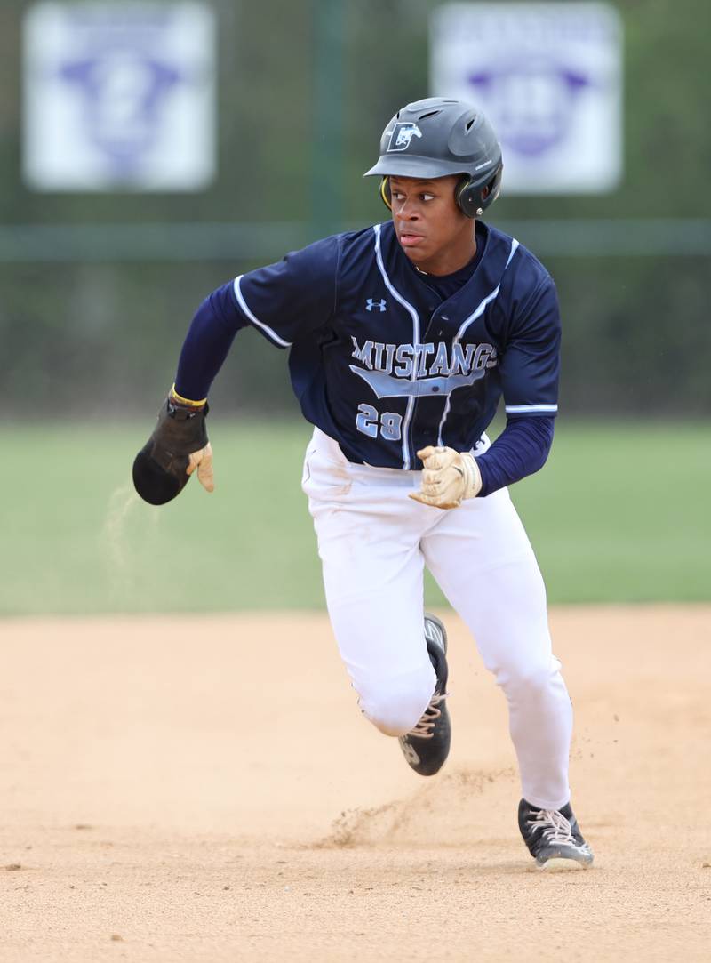 Downers Grove South's Jalen House (29) watches the ball as he runs to third during the varsity baseball game between Downers Grove South and Downers Grove North in Downers Grove on Saturday, April 29, 2023.
