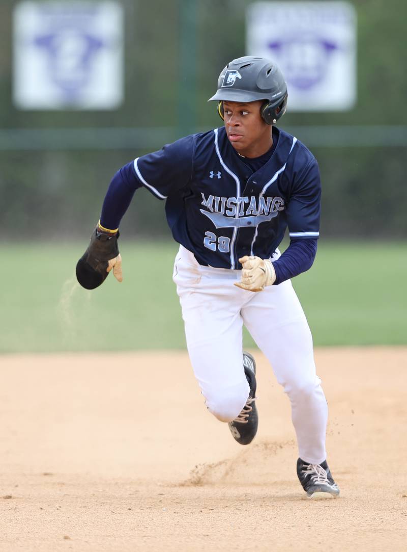 Downers Grove South's Jalen House (29) watches the ball as he runs to third during the varsity baseball game between Downers Grove South and Downers Grove North in Downers Grove on Saturday, April 29, 2023.