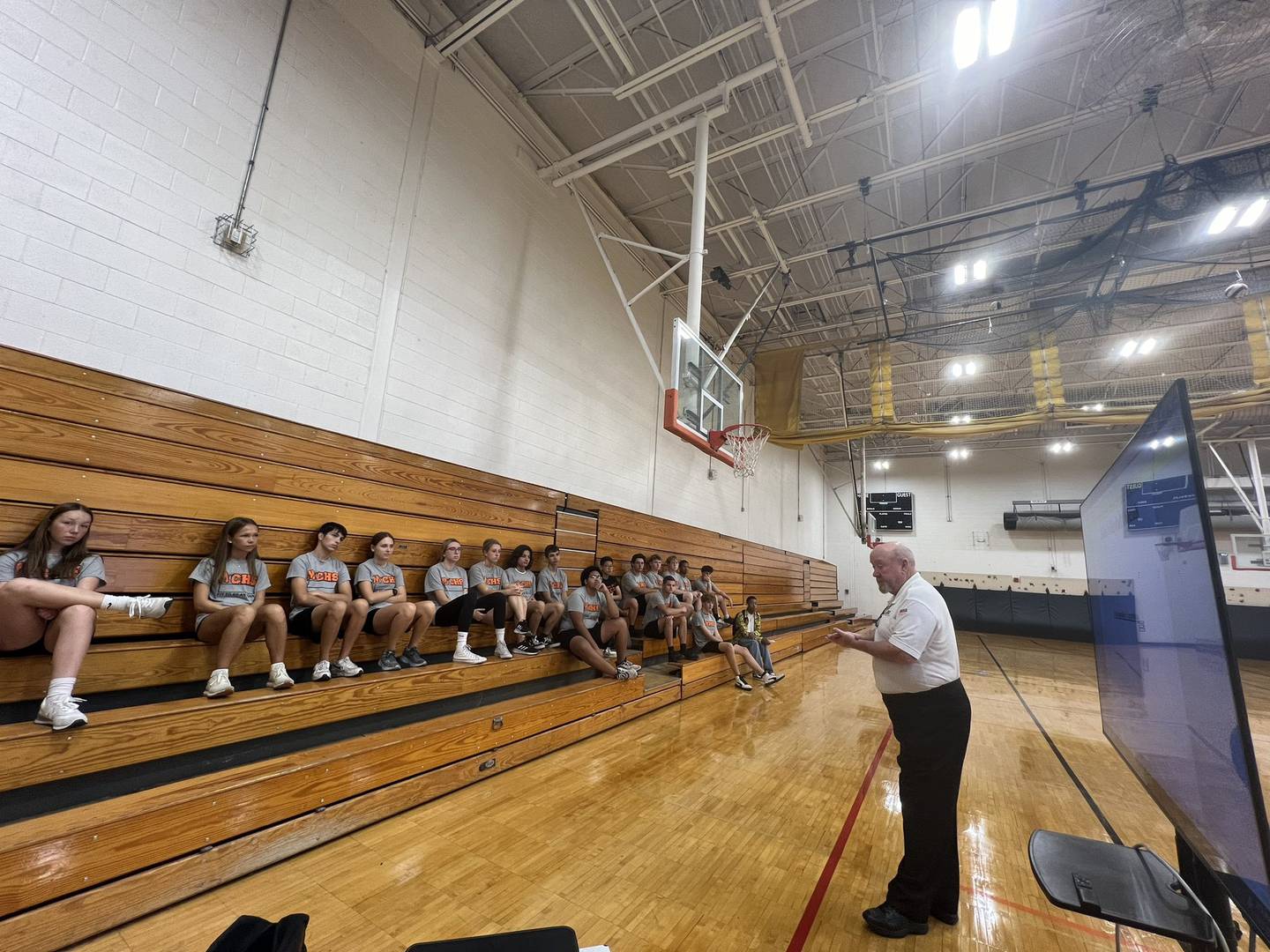 IHSA volleyball and basketball official Dan Feeney (right) speaks to Minooka High School's officiating class. Minooka is one of a growing number of schools offering the class.
