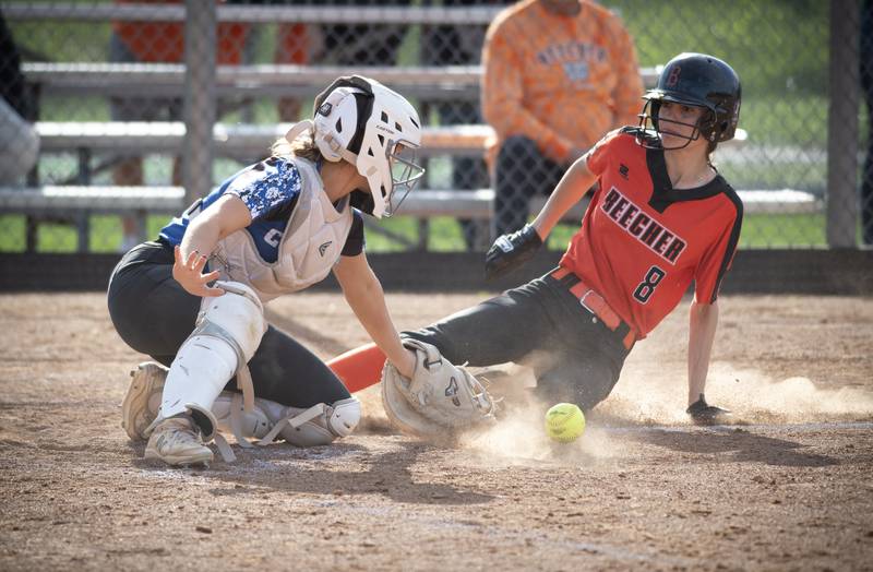 Beecher's Elena Kvasnicka slides safely into home as Central's Keira Donnelly misplays a throw in the fifth inning of a game on April 29, 2025.