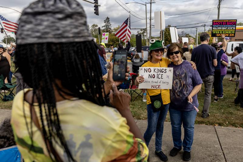 Evelyn Benders takes a photo of Sandy Costa and Mary Schnibben during the No Kings Protest in Joliet on Oct. 18, 2025.