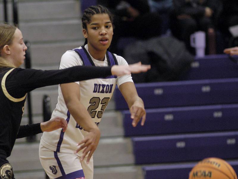 Dixon's Ahmyrie McGowan passes the ball around a Sycamore defender. The Dixon Duchesses beat the Sycamore Spartans 55-47 in a non-conference game played at Lancaster Gym in Dixon on Saturday, December 20th, 2025.