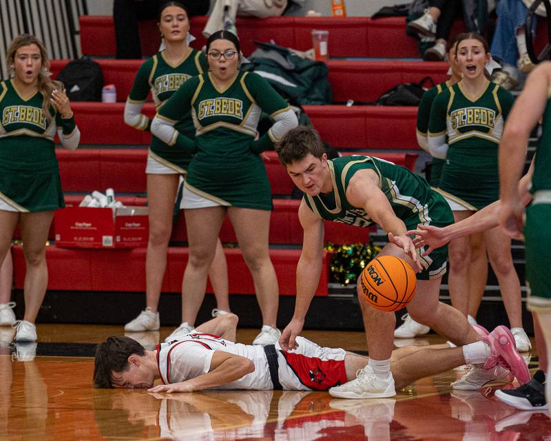 Clayton Fusinetti (21) of Hall lays on floor after failing to retrieve rebound from St. Bede's Aj Hermes (22) on Saturday, January 31, 2026 at Hall High School in Spring Valley.