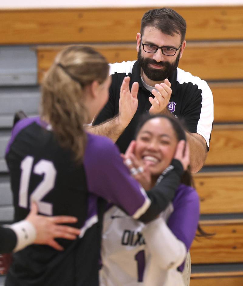 Dixon’s head coach Bunyan Cocar claps after a big point Thursday, Oct. 30, 2025, during their Class 3A regional championship match against Sycamore in Rochelle.