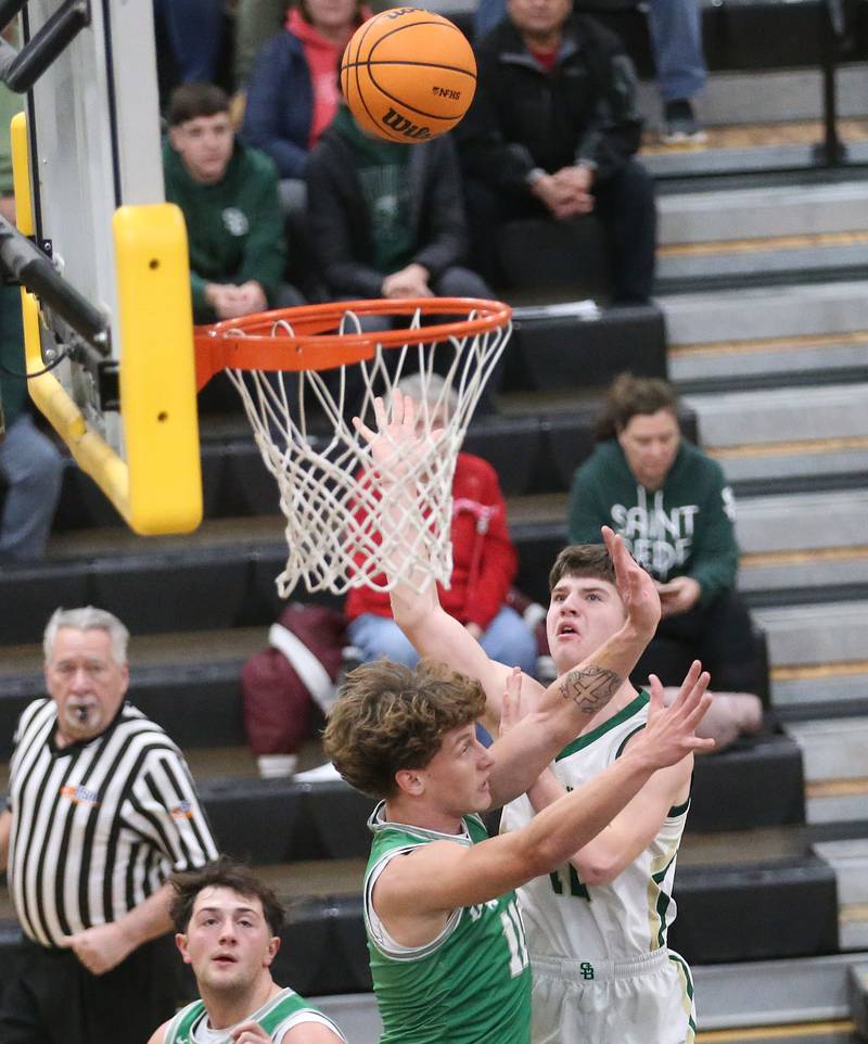 St. Bede's Carson Riva gets the shot off over Dwight's Joey Starks during the Tri-County Conference Tournament on Tuesday, Jan. 27, 2026 at Putnam County High School.