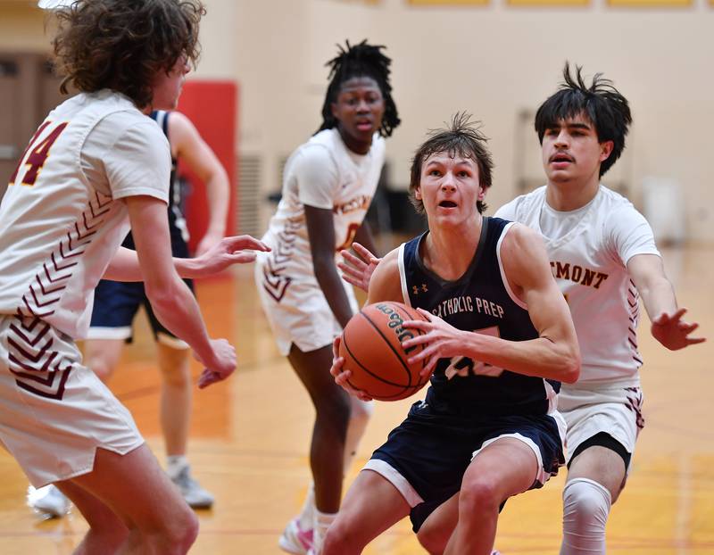 IC Catholic's Danny Fromelt drives the lane with the ball while surrounded by Westmont defenders during a game on Jan. 5, 2024 at Westmont High School in Westmont.