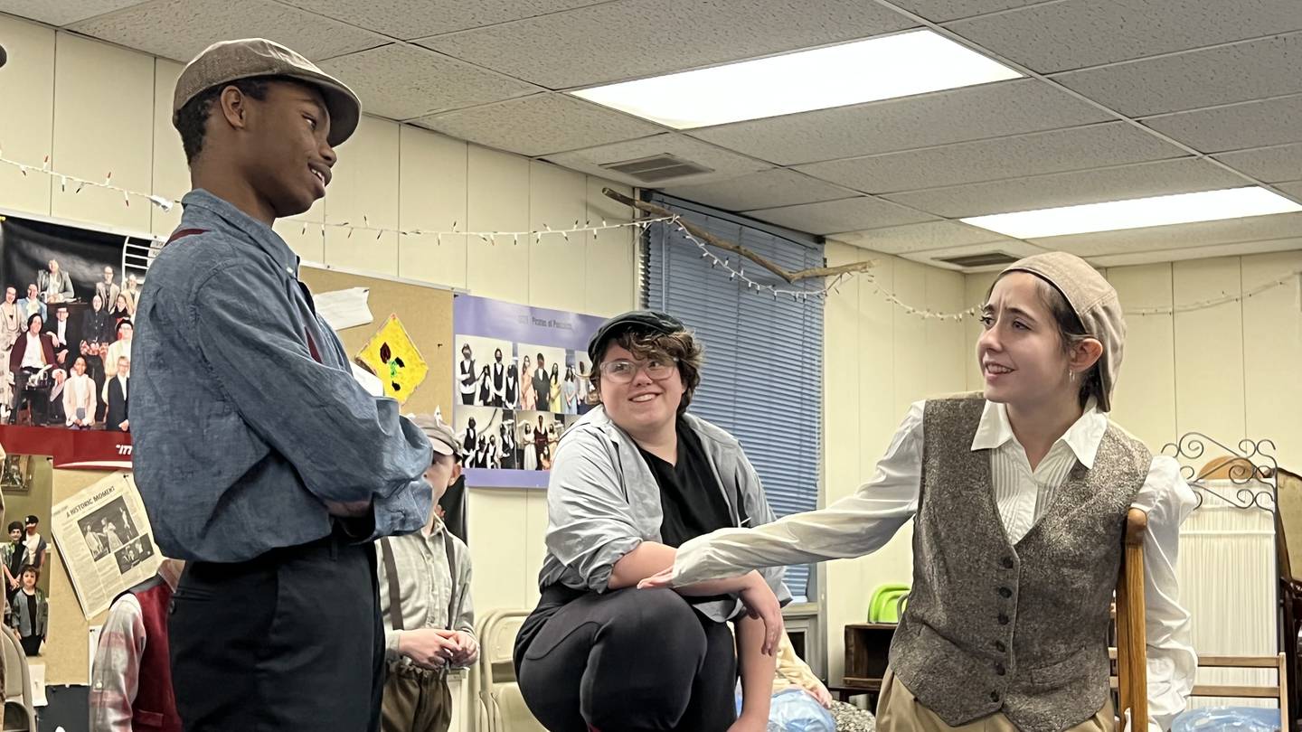 During a Jan. 26 rehearsal at Somonauk Baptist Church, Payton DeWitt, playing Romeo, looks on from the middle as Gio Bianchi, playing Race on the left, interacts with Cadee Goldstein, playing Crutchie on the right.