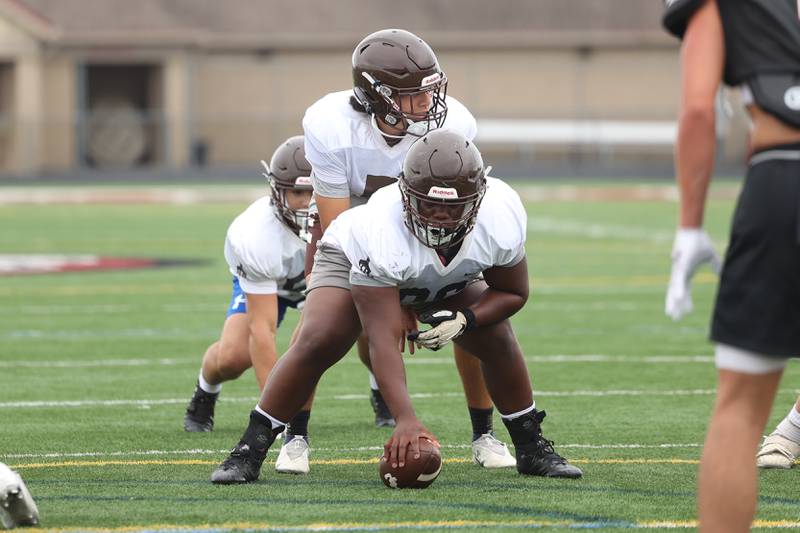 Joliet Catholic quarterback Andres Munoz lines up under center Elijah Watt during a scrimmage against Plainfield North on Thursday, July 13th, 2023 at Plainfield North