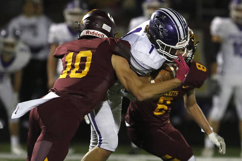 Richmond-Burton's Max Loveall (left) and Jack Martens tackle Rochelle's Grant Gensler during a Kishwaukee River Conference football game on Friday, Oct.20, 2023, at Richmond-Burton High School.