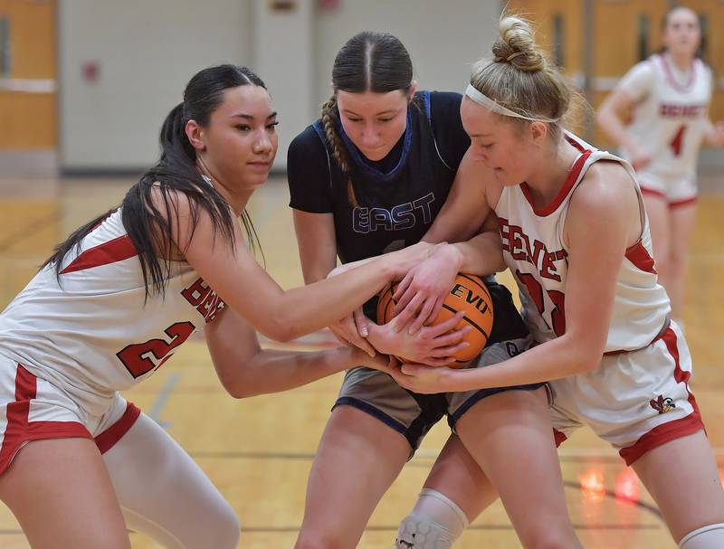 Oswego East’s Aubrey Lamberti is tied up by Benet’s Emma Briggs and Bridget Rifenburg (right) during the Class 4A Benet Regional final on February 19, 2026 at Benet Academy in Lisle.