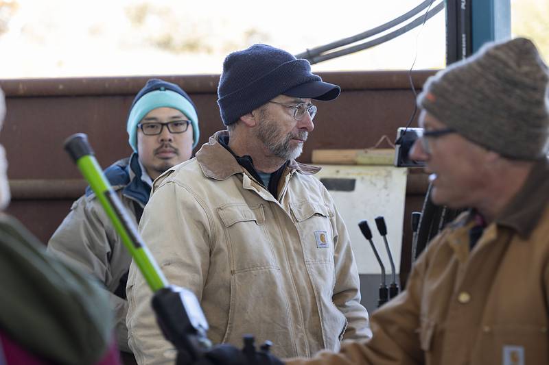 Nachusa Grasslands manager Bill Kleiman works the hydraulics to trap the bison in a chute so vaccinations can be administered. Because the animals are considered domesticated, laws require them to regularly inoculated.