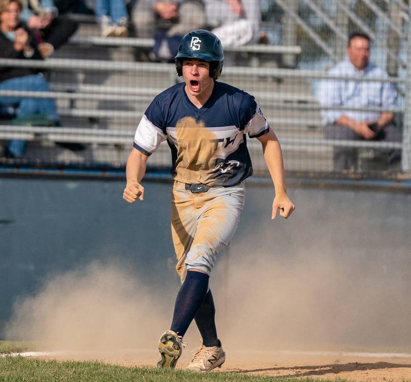 Plainfield South's Ethan Chance (11) reacts after scoring against Oswego during a baseball game at Oswego High School on Monday, April 11, 2022.