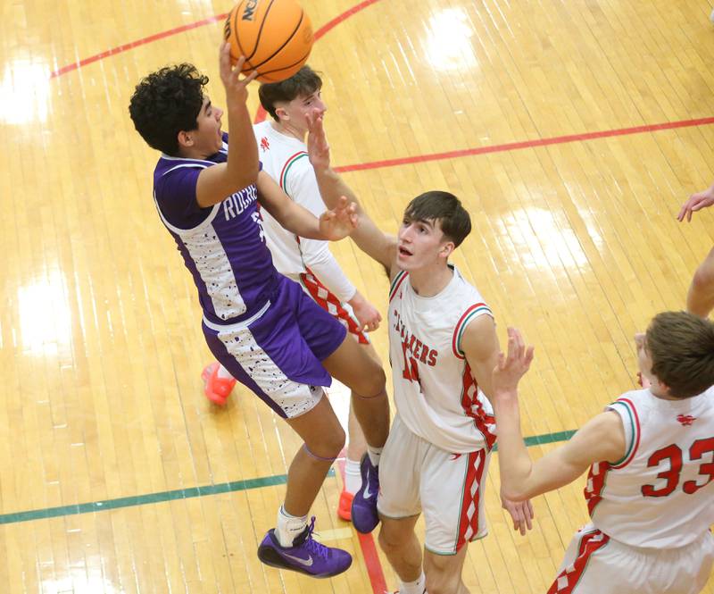 Rochelle's Kasin Avila leaps in the air over L-P's Wyatt Kilday to pass the ball off on Friday, Feb. 13, 2026 in Sellett Gymnasium at L-P High School.