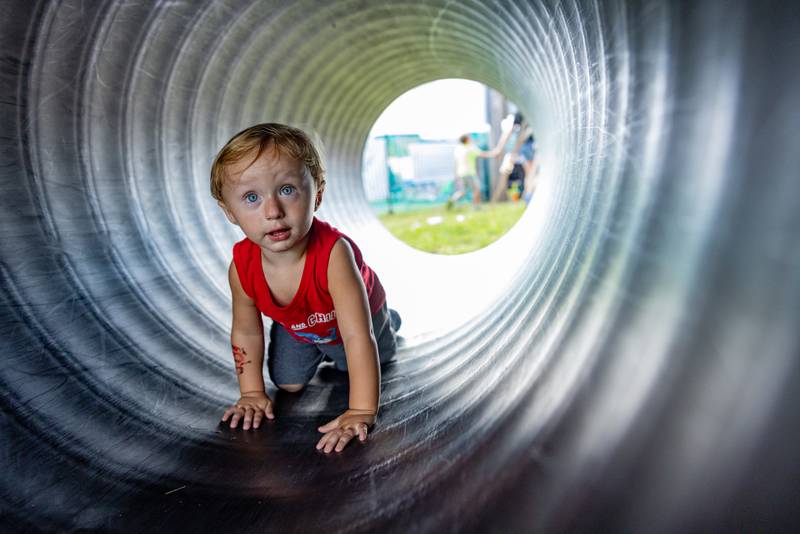 Daxtyn Elliott crawls through a corrugated tube set up at the Marshall Putnam Fair on June 17, 2025 in Henry Illinois.