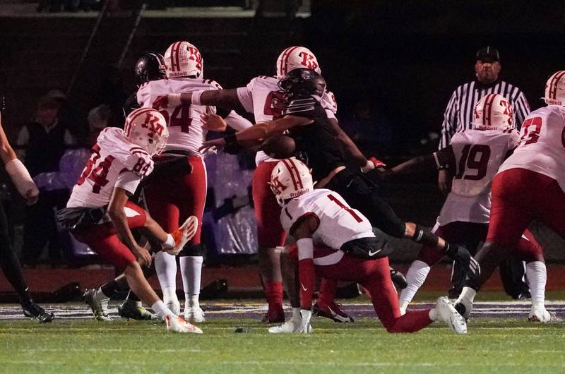 Downers Grove North's Owen Thulin (5) blocks an extra point attempt by Kenwood's Noah Charles (84) during a class 7A playoff football game at Downers Grove North on Friday, Oct. 27, 2023.