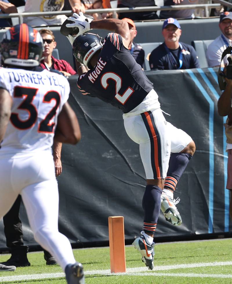 Chicago Bears wide receiver DJ Moore catches a touchdown in front of Denver Broncos safety Delarrin Turner-Yell during their game Sunday, Oct. 1, 2023, at Soldier Field in Chicago.