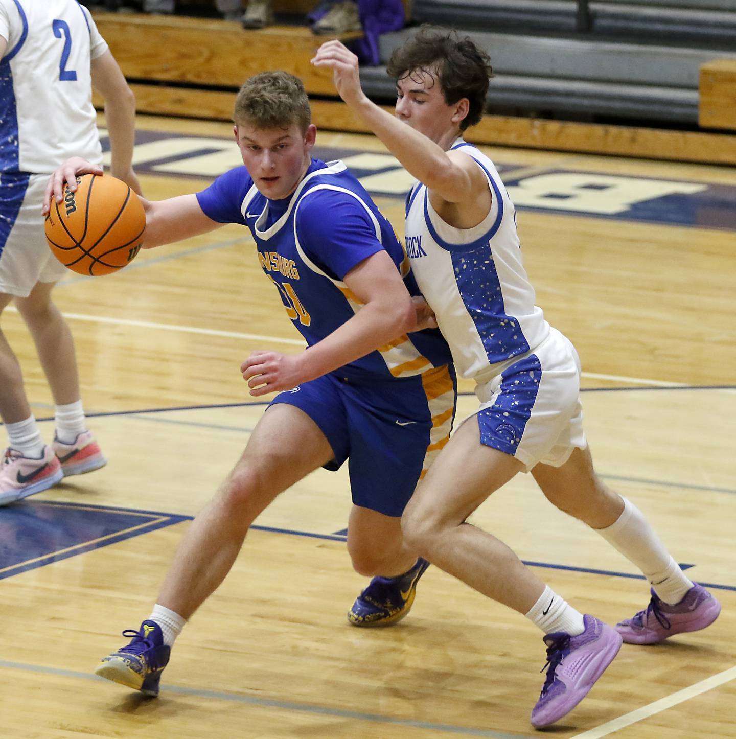 Johnsburg's Jayce Schmitt drives to the basket agains tWoodstock's Collin Greenlee during a Kishwaukee River Conference basketball game on Friday,  Feb. 14, 2025, at Woodstock High School.