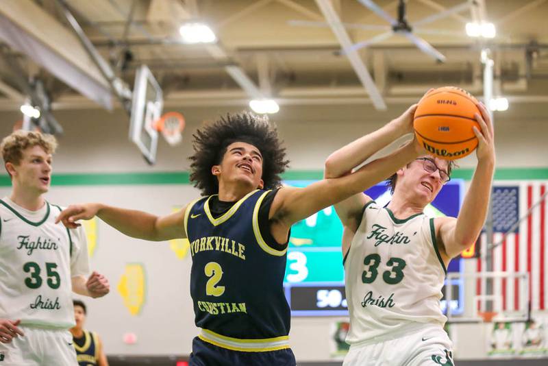 Yorkville Christian's Kayden Maxwell (2) battles Bishop Mcnamara's Callaghan O'Connor (33) for a rebound during their Class 2A Seneca Sectional final basketball game between Bishop McNamara at Yorkville Christian, March 6, 2026 in Senaca.