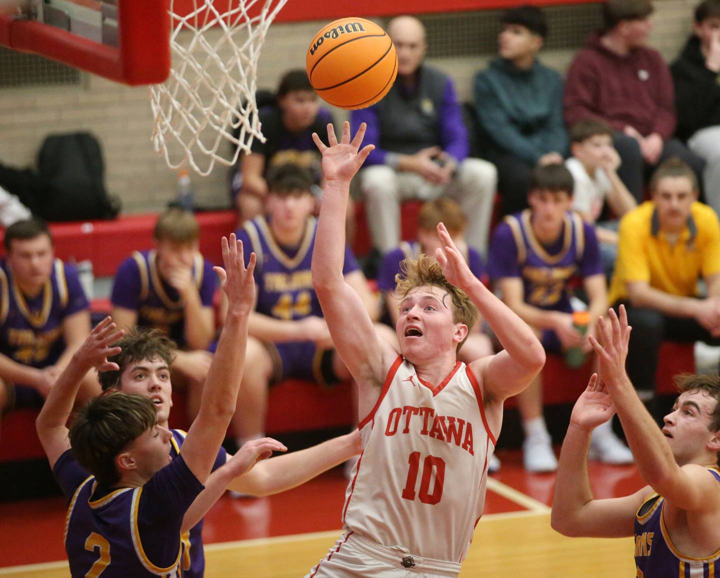 Ottawa's Evan Snook lets go of a shot under the hoop over Mendota's Alex Beetz and teammate Braiden Freeman on Tuesday, Jan. 7, 2025 in Kingman Gym at Ottawa High School.