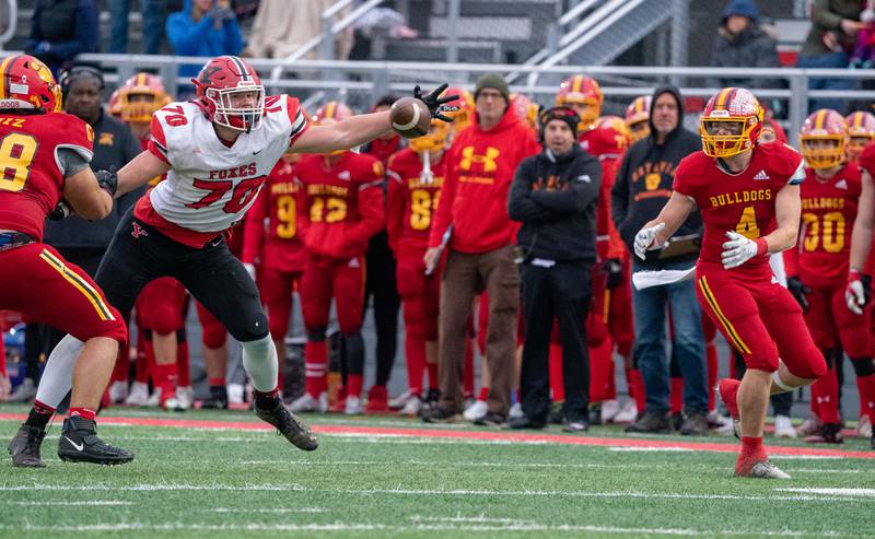 Yorkville's Jack Davies (70) deflects a pass intended for Batavia's Charlie Whelpley (4) during a 7A quarterfinal playoff football game at Batavia High School on Saturday, Nov 12, 2022.