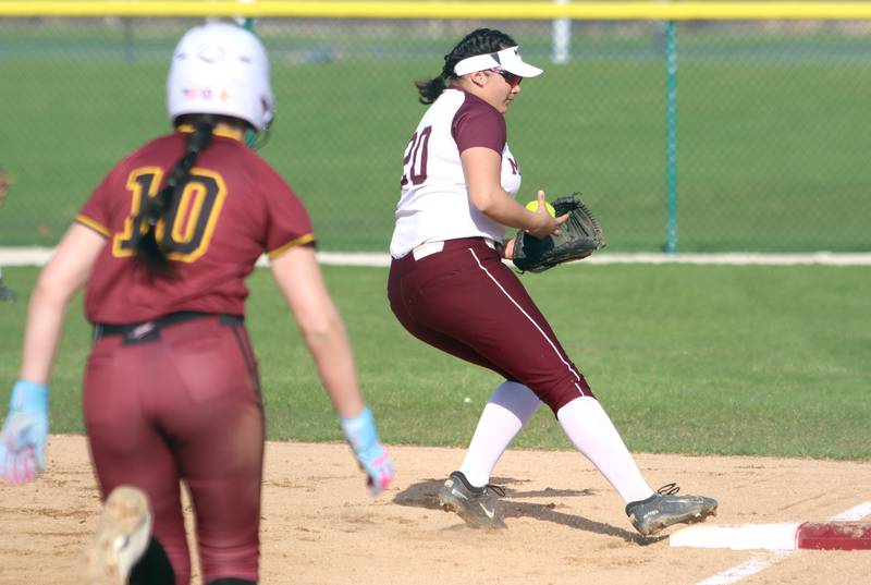 Richmond-Burton’s  Hailey Holtz, left, is forced at first by Marengo’s Arianna Rodriguez in varsity softball on Tuesday, April 22, 2025, at Marengo High School in Marengo.