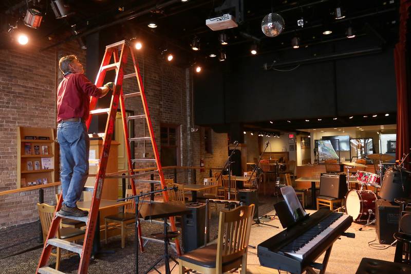 Woodstock Opera House production manager Joe McCormack works on installing stage lighting above the new stage at Stage Left Cafe on Wednesday, April 28, 2021 in Woodstock.