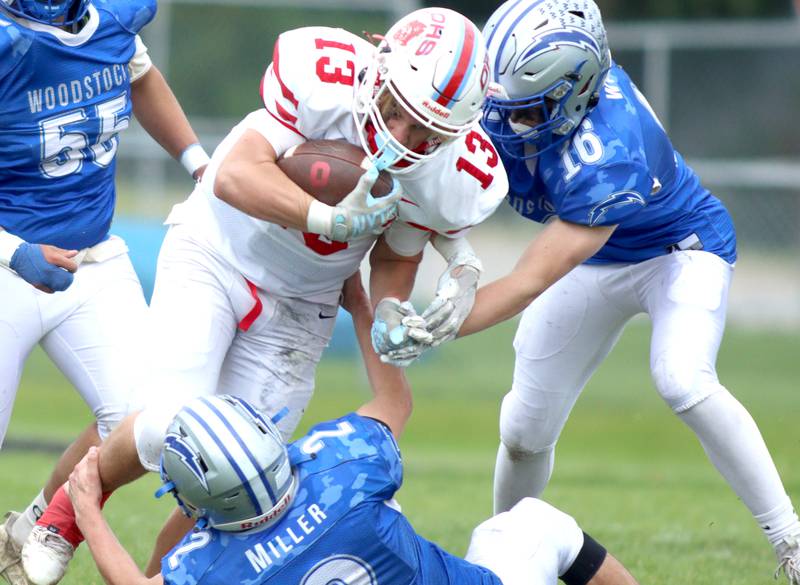 Woodstock’s Charlie Walrod, right, closes in on Ottawa’s Ryder Miller in varsity football at Larry Dale Field on the campus of Woodstock High School Saturday.