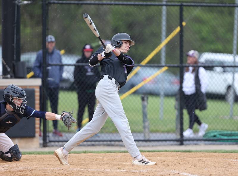 Downers Grove North's Jude Warwick (13) watches his hit during the varsity baseball game between Downers Grove South and Downers Grove North in Downers Grove on Saturday, April 29, 2023.