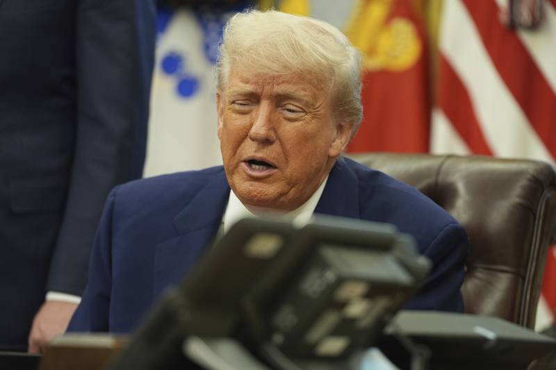 President Donald Trump speaks on the phone to Britian's Prime Minister Keir Starmer on a trade deal between the US and United Kingdom in the Oval Office of the White House, Thursday, May 8, 2025, in Washington. (AP Photo/Evan Vucci)