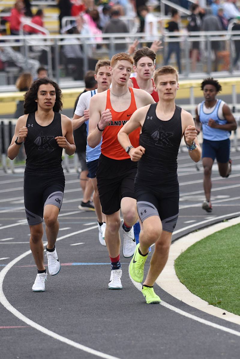 Kankakee's Caleb Haut leads a pack around a corner during the 3,200 m race at the Herscher Invite Friday, May 2, 2025.