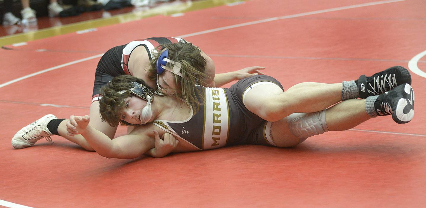 Morris' Aidan Whenner works to get from under Owen Kearfot in the 175-pound match Wednesday at Ottawa