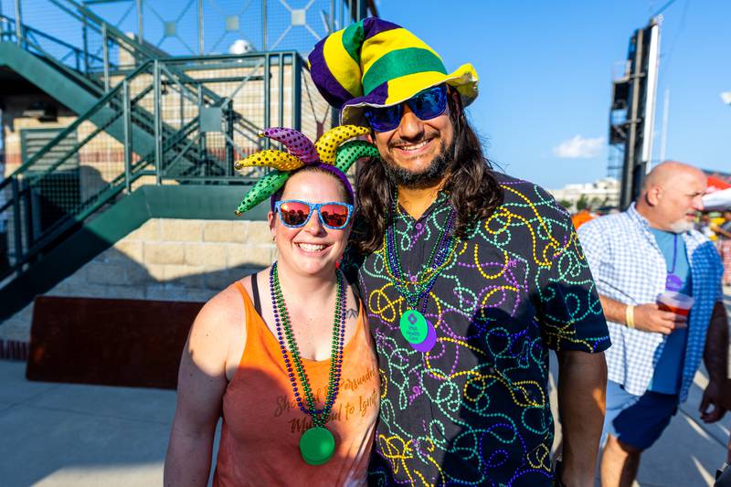 Mokena residents Kelly and Bryan Robinson don their Mardi Gras best during New Orleans North Festival held at the Joliet Slammers Stadium on Aug. 16, 2024.