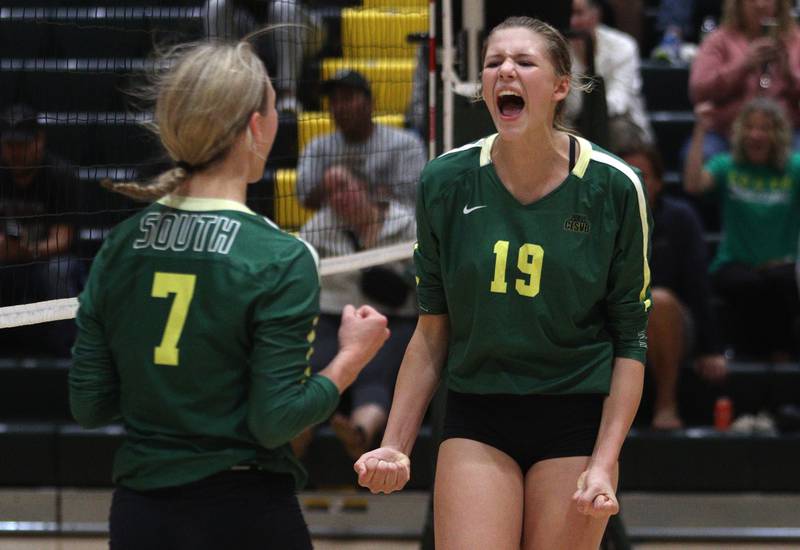 Crystal Lake South’s Logan Georgy, right, and Gabby Wire celebrate a three-set win over Prairie Ridge in varsity volleyball at Crystal Lake South Tuesday night.