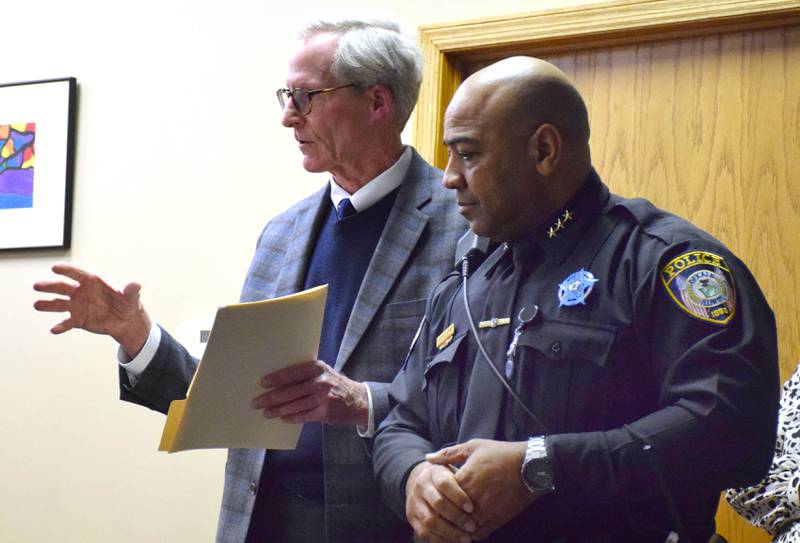 DeKalb City Manager Bill Nicklas, left, Police Chief David Byrd discuss the DeKalb School District hiring additional school resource officers during a Board of Education meeting held Tuesday, April 19, 2022.