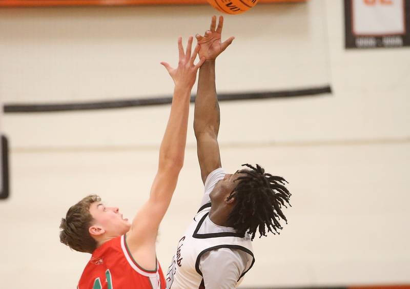 Peoria's Fenix Foy wins the opening jump ball over L-P's Jameson Hill during the Class 3A Sectional semifinal game on Wednesday, March 5, 2025 at Washington High School.