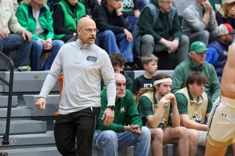 Bishop McNamara head coach Adrian Provost communicates to his team during Bishop McNamara's 71-42 victory over Herscher in the IHSA Class 2A Herscher Regional semifinal on Wednesday, Feb. 25, 2026.