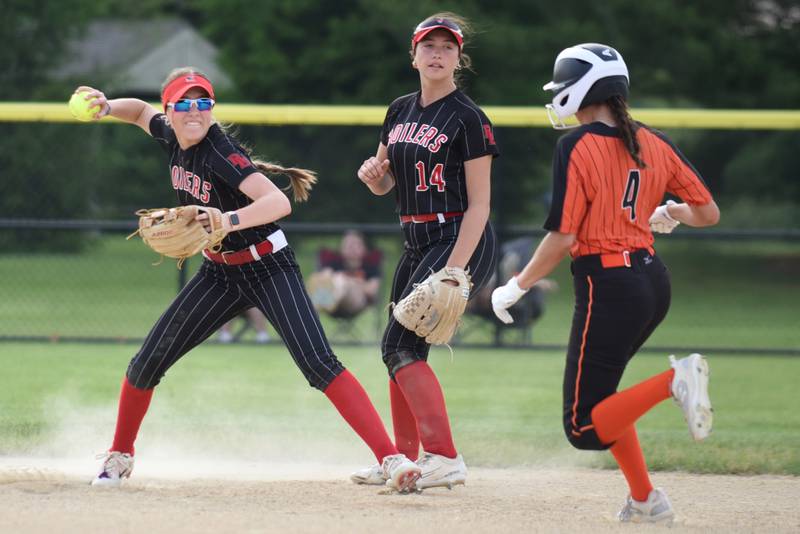 Bradley-Bourbonnais' Shannon Lee, left, throws to first base to complete a double play after forcing Minooka's Payton Psinas (4) out at second base during the Class 4A Normal Community West Sectional semifinals Tuesday, June 3, 2025.